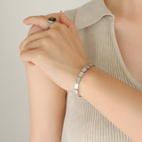 Armband van roestvrij staal, vierkante schakels gegraveerd met Love, vergulde of verzilverde afwerking, model Loïs